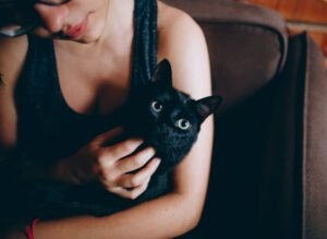 A proud cat mom cuddling her cat — the perfect recipient for a custom cat gift