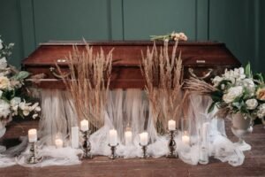 Sympathy flowers and a candle arranged as a comforting pet loss gift