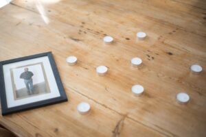 Lighted memorial candle honoring a beloved dog who has passed — a gentle pet loss tribute